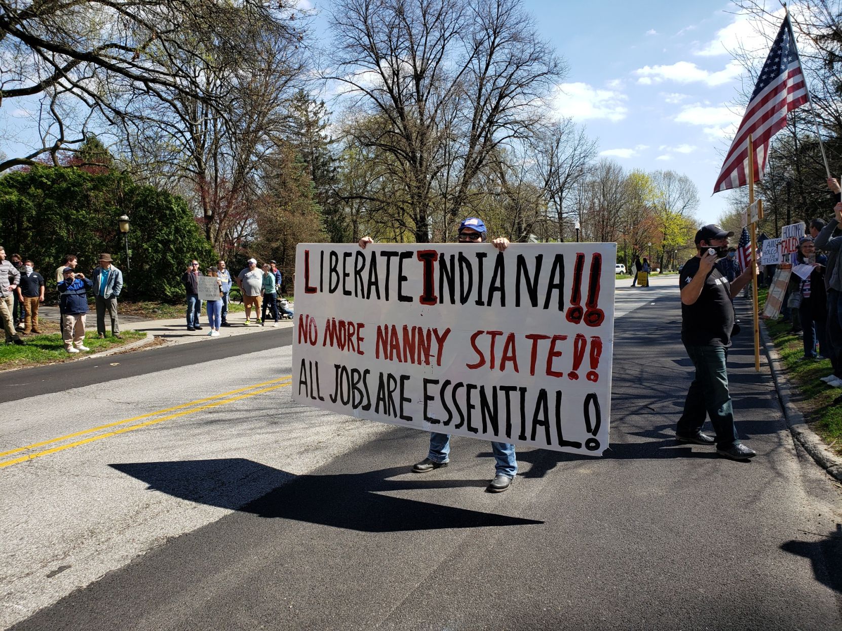 Protester with sign on Meridian St.